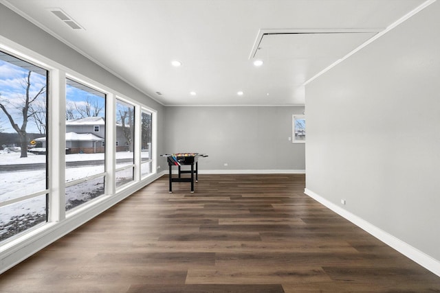 playroom featuring a wealth of natural light, crown molding, and dark hardwood / wood-style floors