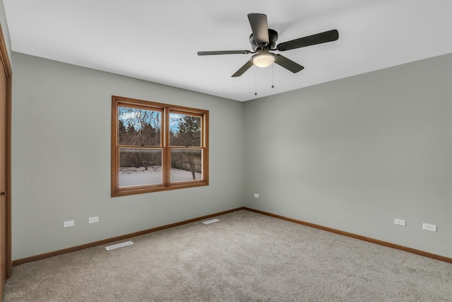 carpeted spare room with ceiling fan