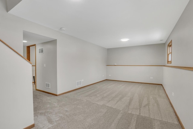 spare room featuring light colored carpet