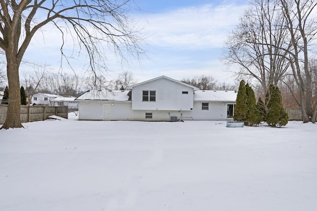 view of snow covered back of property