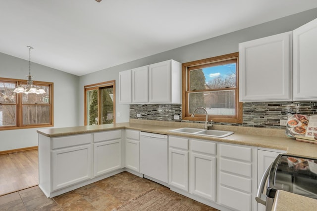 kitchen featuring dishwasher, lofted ceiling, white cabinetry, electric stove, and sink