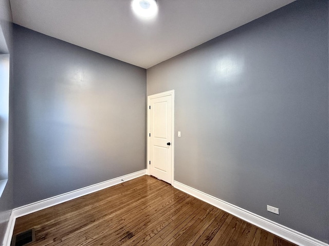 spare room with wood-type flooring