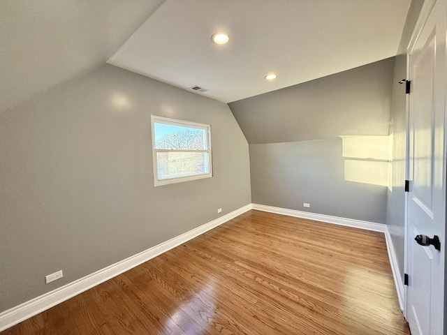 bonus room featuring lofted ceiling and light wood-type flooring