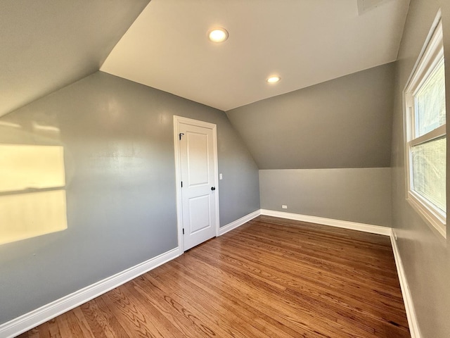 bonus room with lofted ceiling and hardwood / wood-style floors