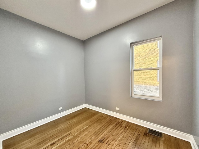 spare room with hardwood / wood-style flooring