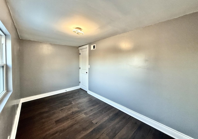 unfurnished room featuring dark hardwood / wood-style floors