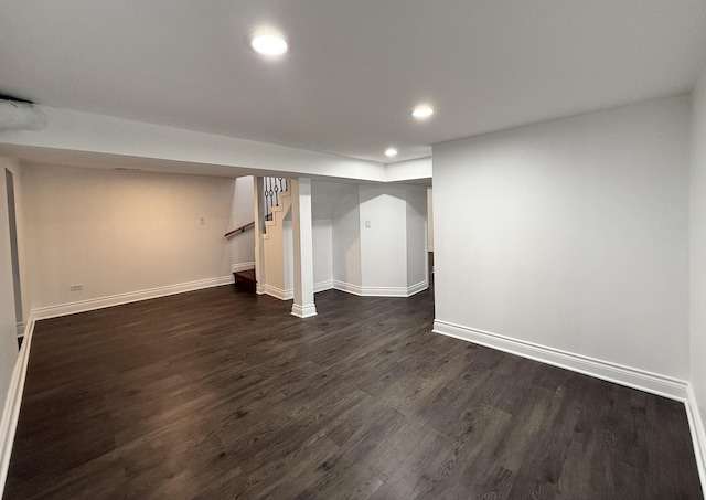 basement with dark hardwood / wood-style floors