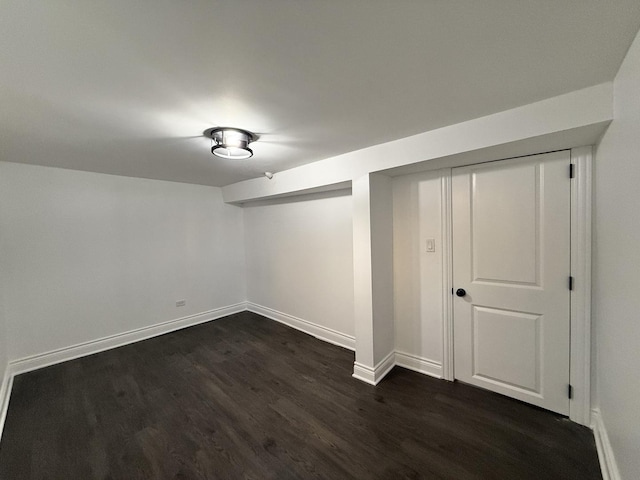 basement with dark hardwood / wood-style floors