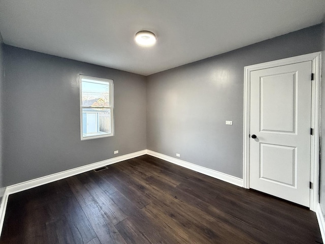 unfurnished room featuring dark hardwood / wood-style flooring