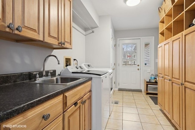 washroom featuring cabinets, independent washer and dryer, sink, and light tile patterned floors