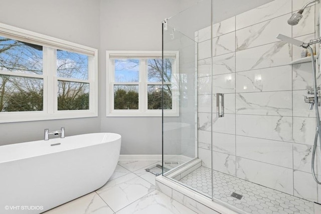 bathroom featuring independent shower and bath