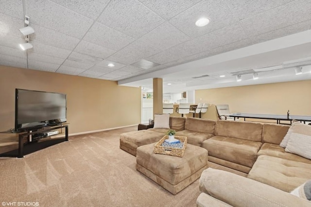 living room with carpet flooring and rail lighting