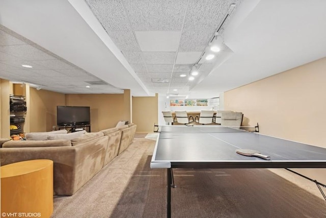 playroom featuring rail lighting and a drop ceiling