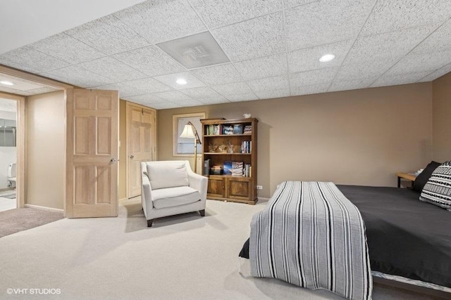 carpeted bedroom with a paneled ceiling