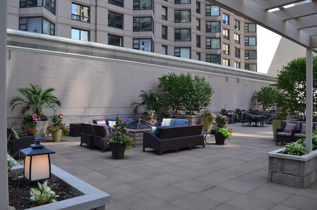 view of patio / terrace with a pergola, a grill, and an outdoor living space with a fire pit