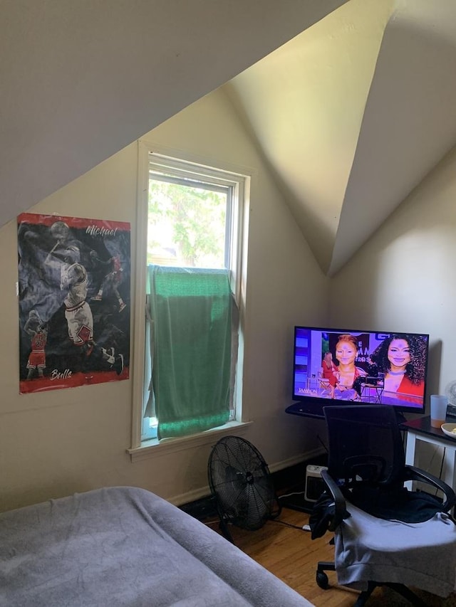 bedroom with lofted ceiling and wood-type flooring