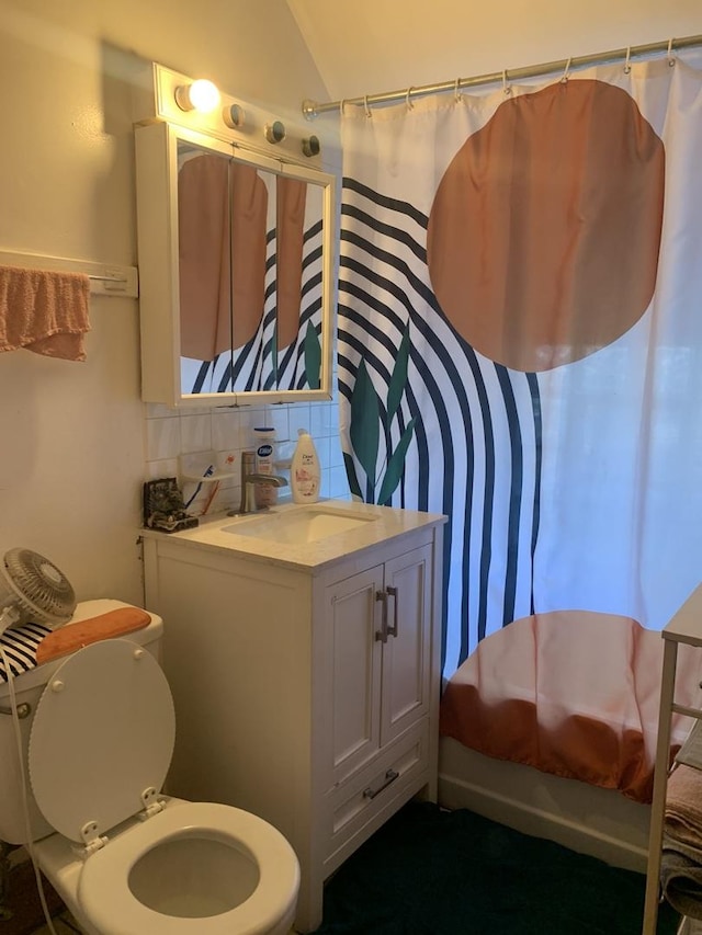 full bathroom with lofted ceiling, vanity, toilet, decorative backsplash, and shower / bath combo with shower curtain