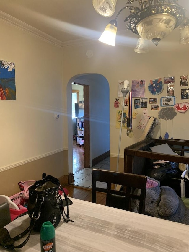 bedroom with ornamental molding and wood-type flooring