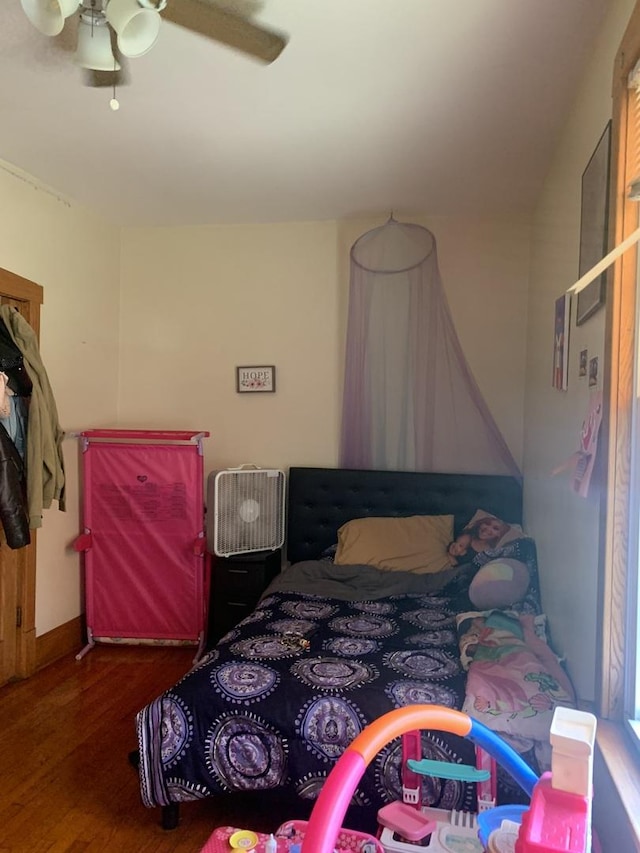 bedroom featuring ceiling fan and dark hardwood / wood-style floors