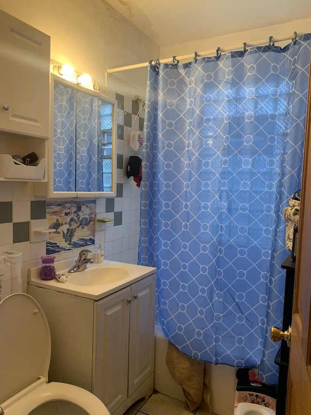 full bathroom featuring toilet, decorative backsplash, shower / bath combo with shower curtain, tile walls, and vanity