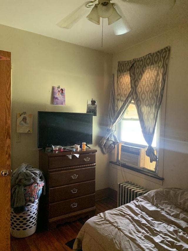 bedroom featuring ceiling fan, dark wood-type flooring, cooling unit, and radiator heating unit