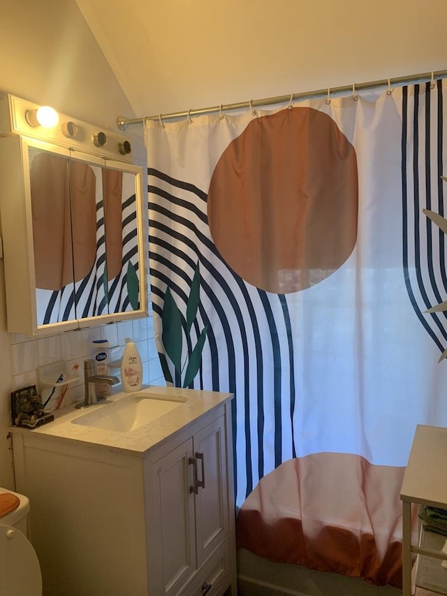 bathroom with a shower with shower curtain, decorative backsplash, lofted ceiling, and vanity