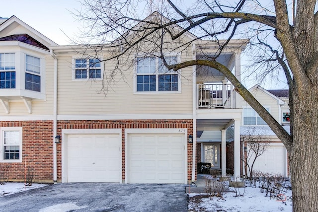 view of front of home featuring a garage and a balcony