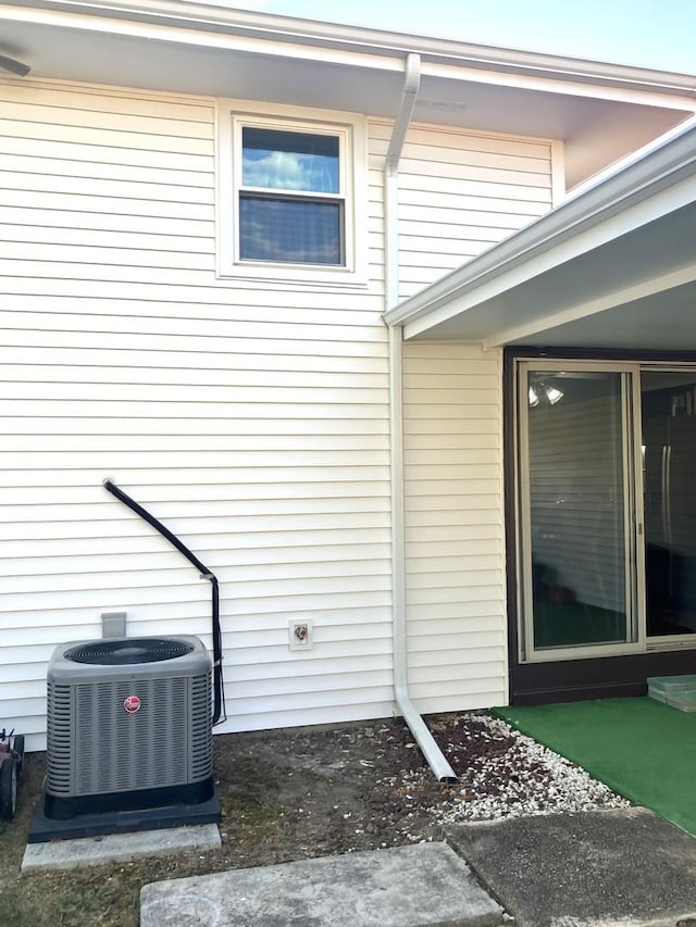 view of property exterior with central AC unit