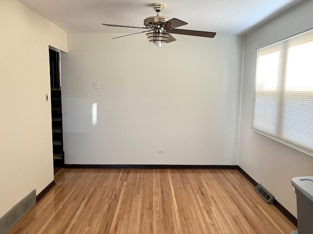 unfurnished room with ceiling fan and light hardwood / wood-style flooring