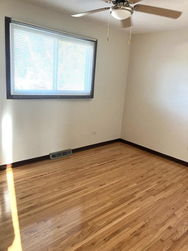 spare room featuring light hardwood / wood-style flooring and ceiling fan