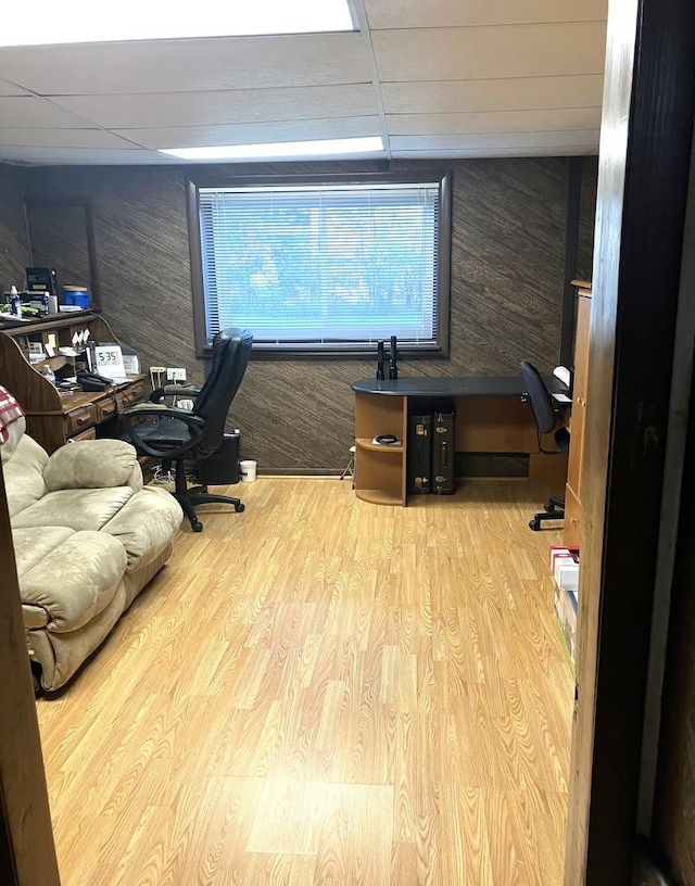 office area featuring a paneled ceiling and light wood-type flooring