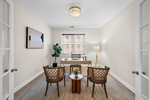 office space featuring french doors and wood-type flooring