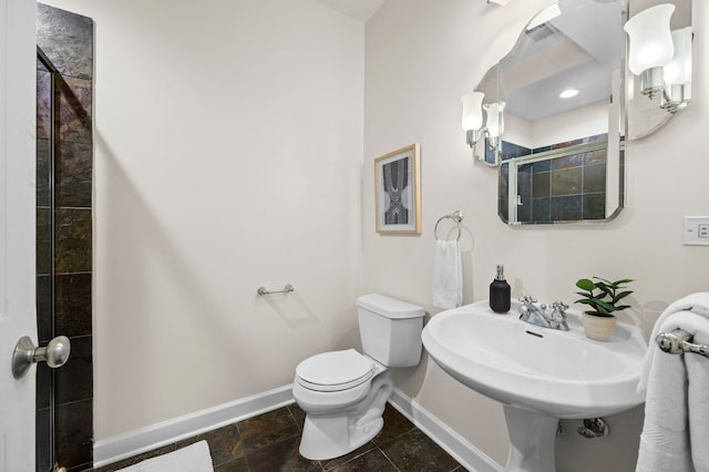 bathroom with sink, toilet, and walk in shower