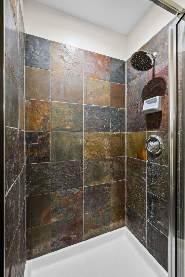 bathroom with a tile shower