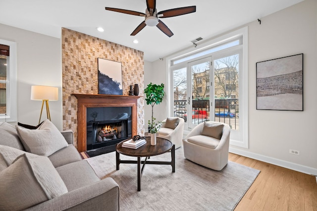 living room featuring ceiling fan and light wood-type flooring