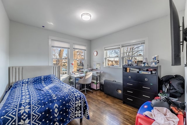 bedroom with dark hardwood / wood-style flooring