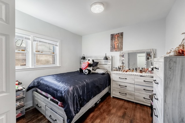 bedroom with dark hardwood / wood-style floors