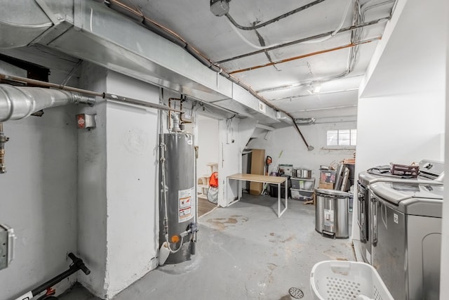 basement featuring gas water heater and washing machine and clothes dryer