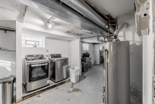 basement with plenty of natural light, washing machine and dryer, and water heater