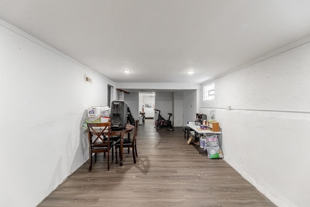 dining area featuring ornamental molding and hardwood / wood-style flooring