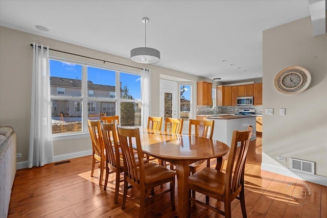 dining space featuring light hardwood / wood-style floors