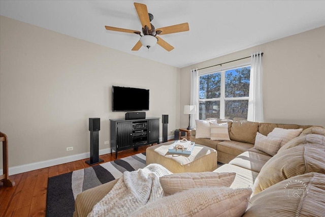 living room with ceiling fan and dark hardwood / wood-style flooring