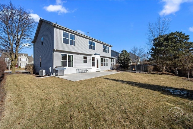 rear view of house with a lawn, a patio, and central air condition unit