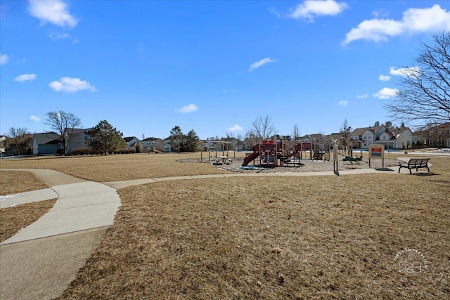 view of property's community with a yard and a playground