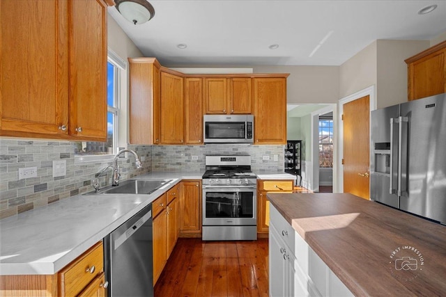 kitchen featuring stainless steel appliances, tasteful backsplash, sink, and dark hardwood / wood-style floors