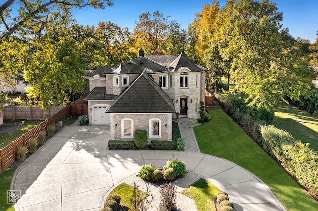 840 Chestnut St, Hinsdale, IL 60521 - french country style house featuring stone siding, concrete driveway, a garage, and roof with shingles