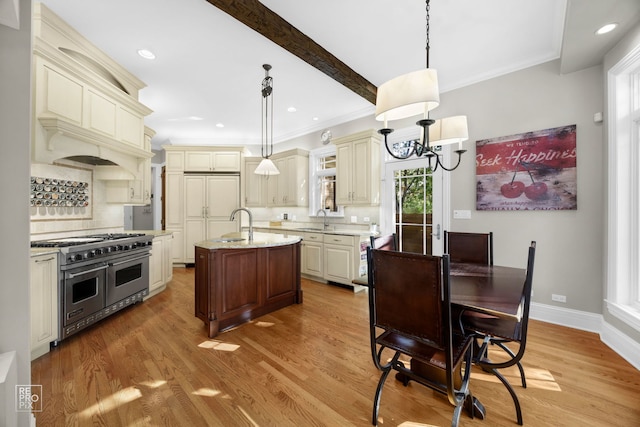 840 Chestnut St, Hinsdale, IL 60521 - kitchen featuring double oven range, cream cabinets, a sink, decorative backsplash, and a kitchen island with sink