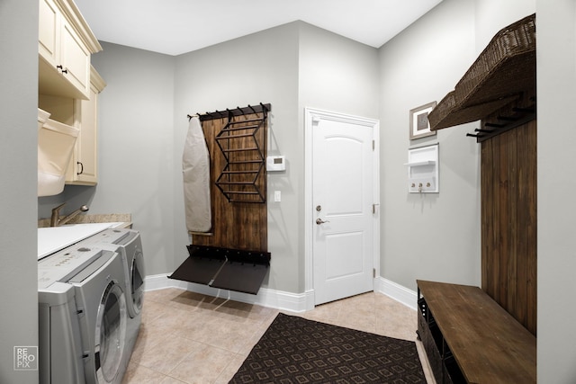 840 Chestnut St, Hinsdale, IL 60521 - washroom featuring cabinet space, independent washer and dryer, light tile patterned floors, and baseboards