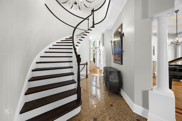 840 Chestnut St, Hinsdale, IL 60521 - staircase featuring a chandelier, granite tiled floors, baseboards, decorative columns, and a towering ceiling