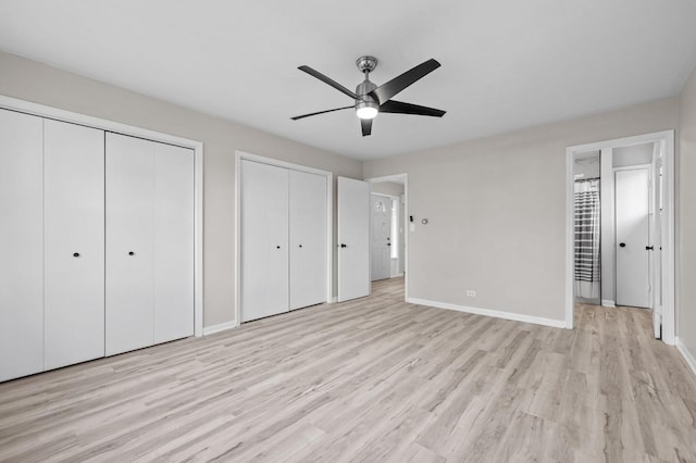 unfurnished bedroom with ceiling fan, multiple closets, and light hardwood / wood-style flooring